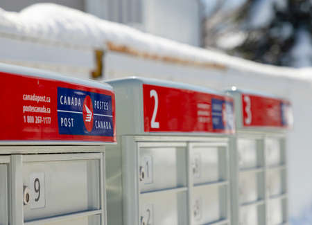 Calgary, Alberta. Canada. Apr 20, 2022. Close up of a Canada Post mailbox from a community neighbourhood during winter.のeditorial素材