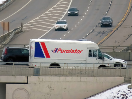 Calgary, Alberta, Canada. Oct 13, 2022. A FedEx delivery truck during the day crossing the street.