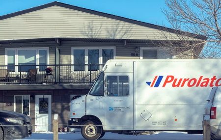 Calgary, Alberta, Canada. Dec 22, 2022. A Purolator delivery truck in front of a house.のeditorial素材