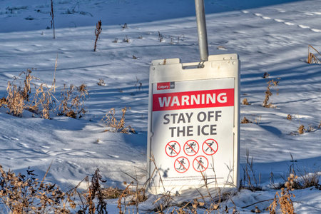 Calgary, Alberta, Canada. Jan 22, 2023. A sign with the text: WARNING STAY OFF THE ICEのeditorial素材