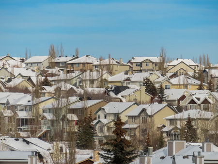 Several houses roofs cover with snow after a heavy blizzard snow fall during winter.の写真素材