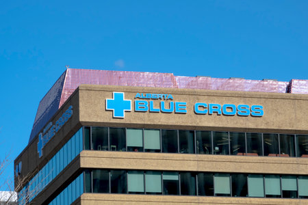 Edmonton, Alberta, Canada. Apr 3, 2023. Front view to the An Alberta Blue Cross sign on top of a building. Concept: Employer Group Benefits Planのeditorial素材