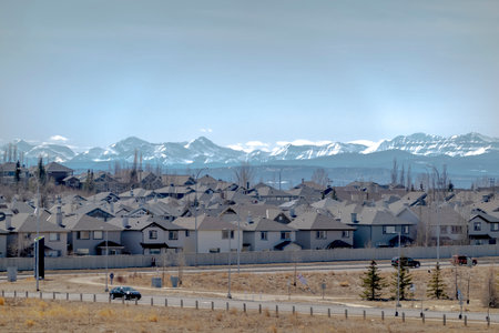 The neighbourhood of Evaston in Calgary Alberta Canada, with the Rocky Mountains on the background. Concept: Alberta real estate house market.のeditorial素材