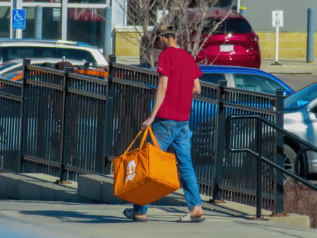 Calgary, Alberta, Canada. Apr 30, 2023. A Skip the dishes delivery person. Concept: Delivery food industry.のeditorial素材