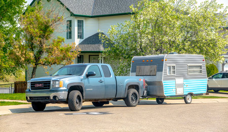 Calgary, Alberta, Canada. May 18, 2023. A blue Truck with a vintage camping trailer RV.のeditorial素材