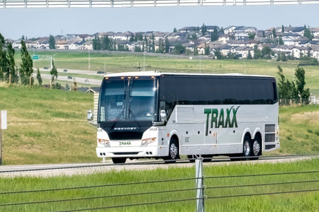 Calgary, Alberta, Canada. Jun 4, 2023. A Traxx bus transportation and logistics company on the highway during the spring.のeditorial素材
