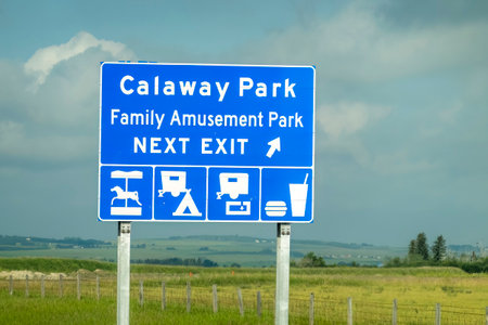 Calgary, Alberta, Canada. Aug 1, 2023. A traffic sign with the text: Calaway Park Family Amusement Park NEXT EXIT.のeditorial素材