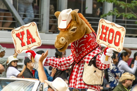 Calgary, Alberta, Canada. July 7, 2023. Harry the Horse Stampede mascot holding a couple of signs that said YAHOO at a public parade.のeditorial素材