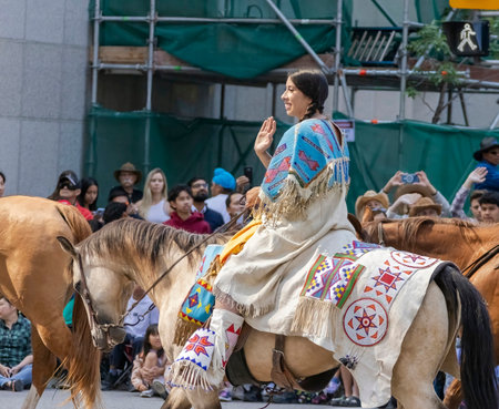 Calgary, Alberta, Canada. July 7, 2023. A First Nation indigenous native woman riding a horse at a public parade.のeditorial素材
