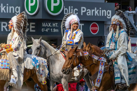 Calgary, Alberta, Canada. July 7, 2023. Some First Nations people wearing traditional cloths while riding horses at a public festival parade.のeditorial素材
