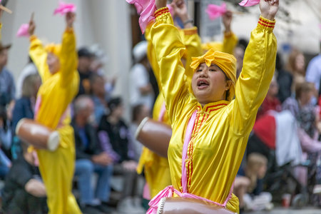 Calgary, Alberta, Canada. July 10, 2023. A Chinese person dancing at a public parade with a traditional cloths.のeditorial素材