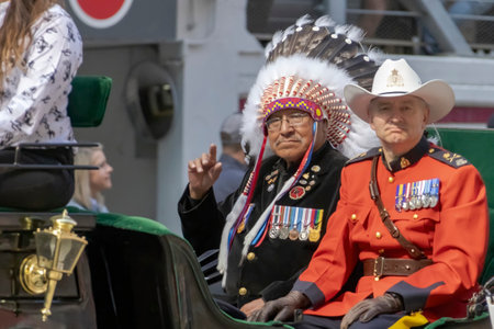 Calgary, Alberta, Canada. July 7, 2023. A First Nation and a Royal Canadian Mounted Police member at a public parade.のeditorial素材