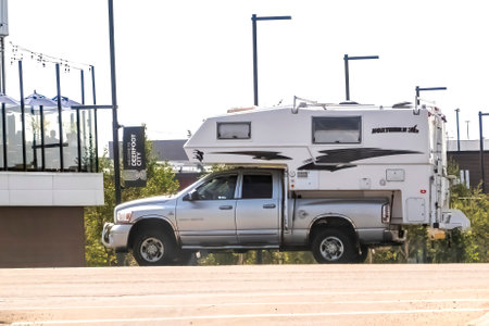 Calgary, Alberta, Canada. Aug 7,2023. A pickup truck with a truck box camper on the route to camp during summer.のeditorial素材