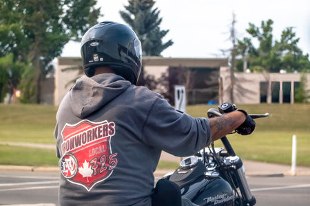 Calgary, Alberta, Canada. Aug 5, 2023. A close up to a motorcycle driver not wearing proper clothing during summer.のeditorial素材
