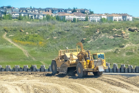 Cochrane, AB, Canada. Aug 13 ,2023. A wheel tractor scrapers excavator on a construction site.のeditorial素材