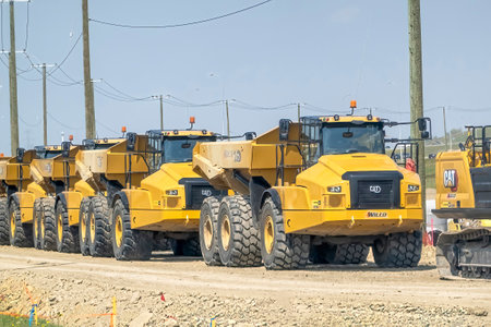 Calgary, Alberta, Canada. Aug 7,2023. Several Caterpillar 740 Ejector trucks. Articulated Truck is...