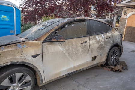 Calgary, Alberta, Canada. Oct 10, 2023. An electric Tesla car with fire damage in from a front house garage.のeditorial素材