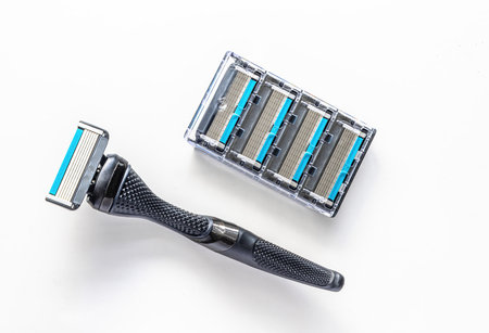 A razor with a metal handle and four six-blade razor cartridges.の写真素材