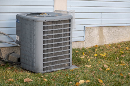 Calgary, Alberta, Canada. Oct 10, 2023. Air conditioner compressor unit. Essential component for cooling systems during summer time.のeditorial素材