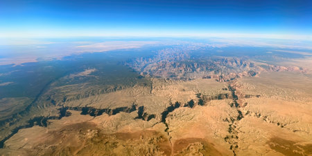 An aerial view of the Grand Canyon, showcasing its immense depth and the vast expanse of the surrounding desert landscape.の写真素材
