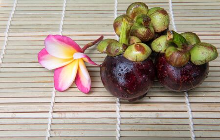 mangosteen Thai fruit delicious sweet  on a wooden backgroundの写真素材