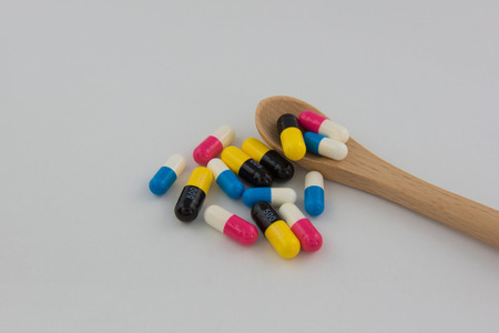 Pills and capsules drug colorful and spoon backgroundの写真素材