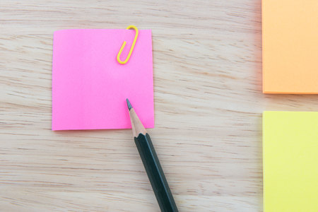 Color  Paper notes with sticky note on Wood Background