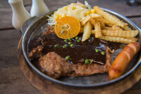 Pork steak on a wooden tableの写真素材
