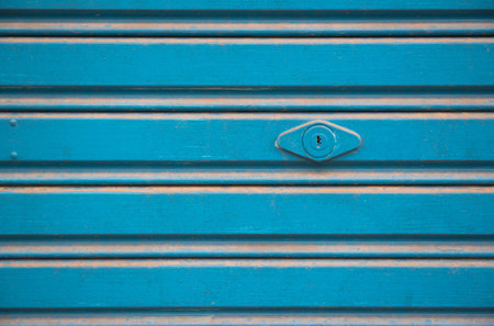 Blue steel door closed and key. Texture pattern and backgroundの写真素材