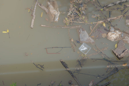 Garbage floating in river, Water pollution. Ecological problem