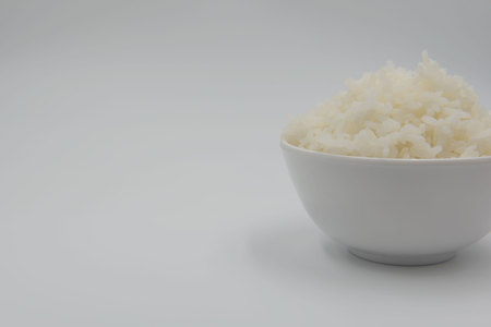 Cooked rice in a bowl on a white background.の写真素材