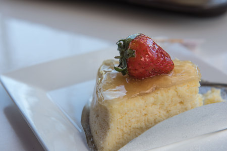 Strawberry cheesecake On a white plate .