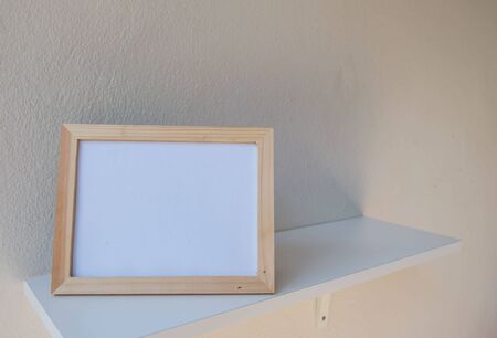 photo Frame on a wooden on White background .の写真素材