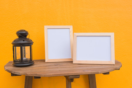 Two photo Frame and lamp on a wooden on Yellow background .の写真素材
