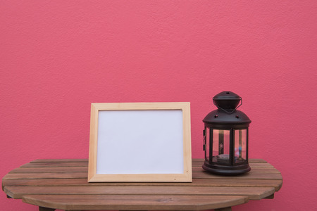 photo Frame on a wooden and Lantern on pink background .の写真素材