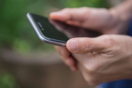 Closeup  phone use telephone in hand. Lifestyle for people.の写真素材