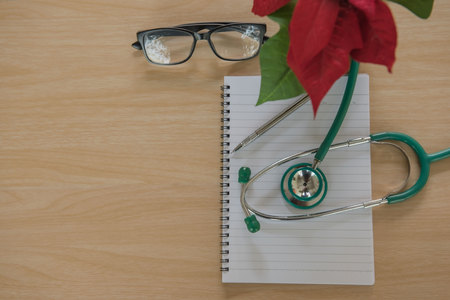 Top view stethoscope Medical equipment and book on wooden background. Doctor workplace in office .の写真素材