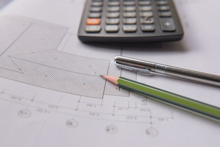 pencil  pen and calculator on blueprints. Architectural and engineering housing concept.の写真素材