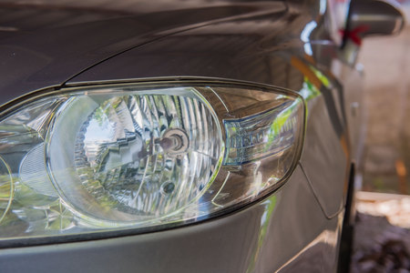 Closeup modern front a car headlight .