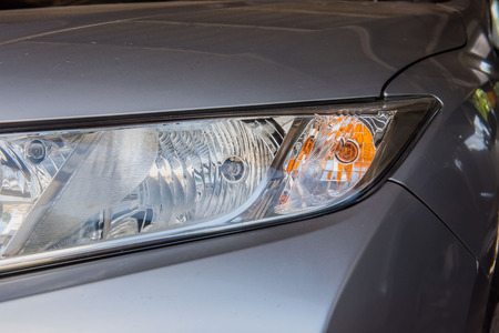 Closeup modern front a car headlight .