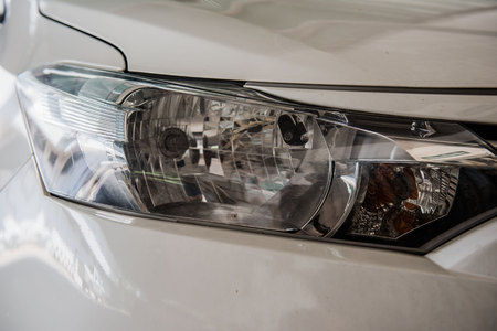 Closeup modern front a car headlight .の写真素材