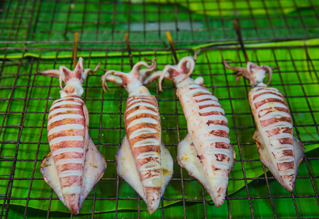 Grilled Fresh Squid in the market, street food in Thailand