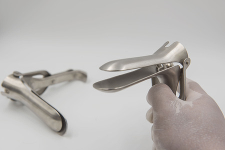 speculum in  hand doctor on white background.Medical concept .の写真素材