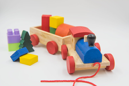 Toy train made of colorful wood on a white background.の写真素材