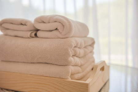 White towels on the table in the room and white curtains background .の写真素材