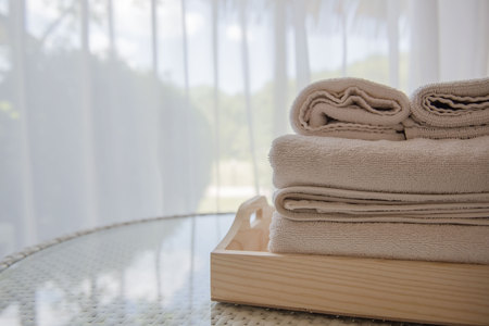 White towels on the table in the room and white curtains background .の写真素材