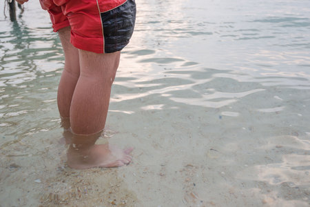 Man standing at the beach by the sea at morning .の写真素材