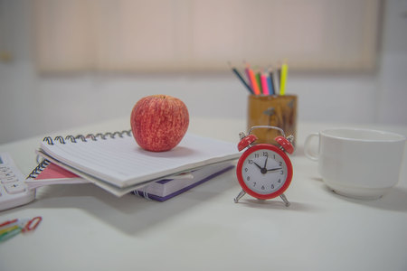 Back To School concept red apple and book on white table .の写真素材
