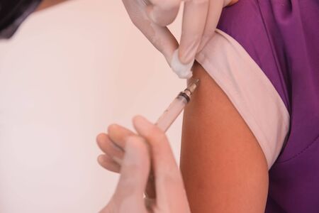 closeup of doctor injecting patient with syringe in the hospital . health care.