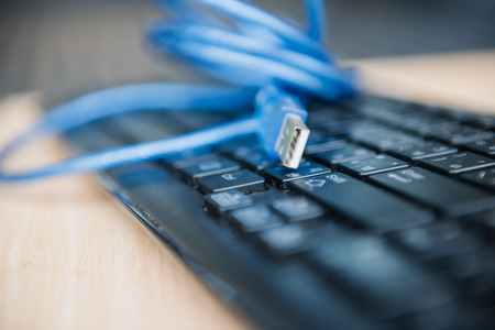 closeup  USB cable on keyboard . Technology concept.の写真素材